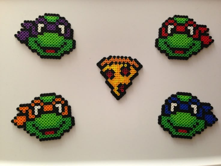 four perler beads are arranged in the shape of teenage mutant turtles