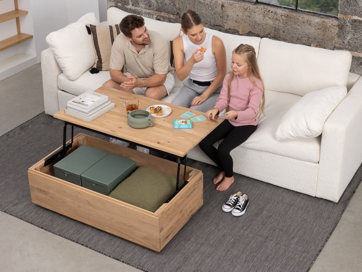 a family sitting on a couch in the living room with their food and drink trays