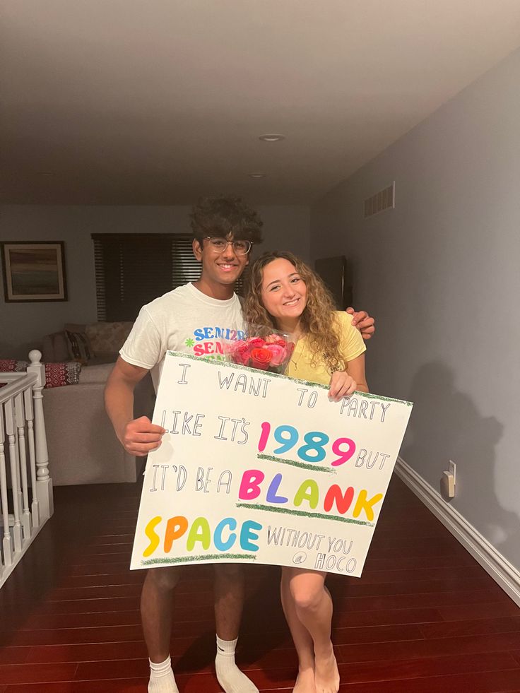 a man and woman holding up a sign that says, i want to party like it's 1989 but it'd be blank space without you