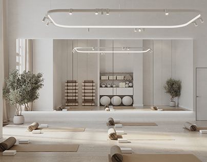 an empty yoga studio with white walls and flooring is pictured in this image, there are many mats on the floor