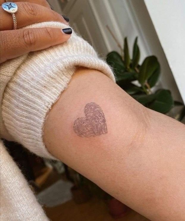 a woman's arm with a fingerprint on the left side of her arm