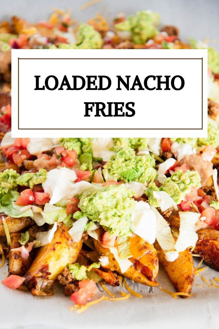 loaded nacho fries with guacamole and sour cream on the top, topped with avocado