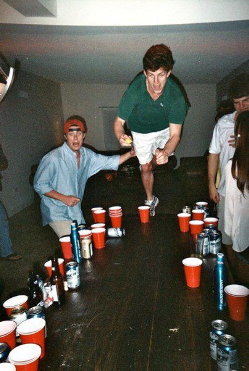 a group of people standing around a table filled with cups