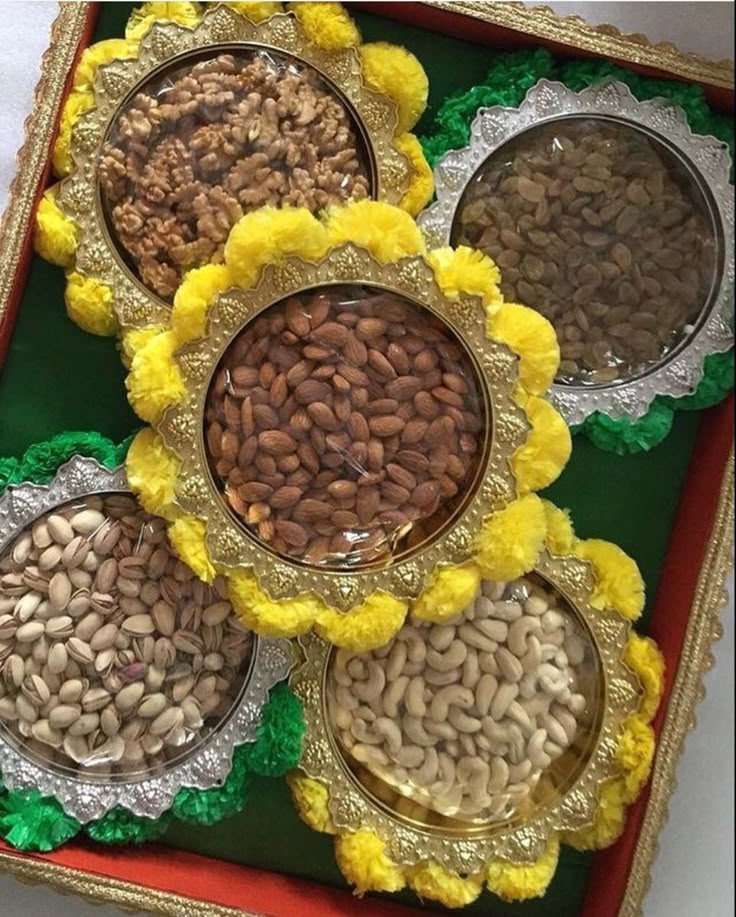 there are five bowls with nuts in them on the trays and one is empty