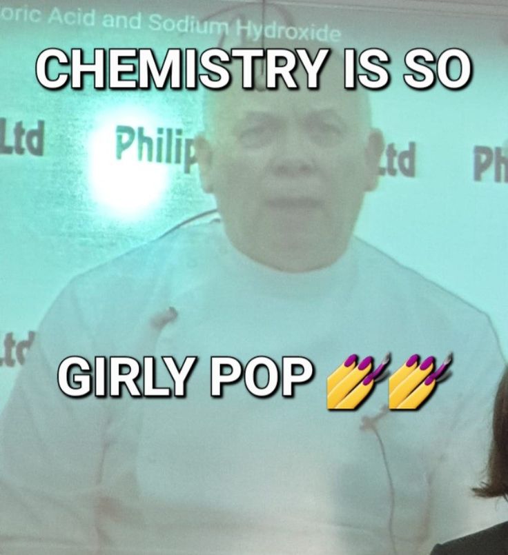 a woman standing next to a man in front of a screen with the words, chemistry is so girly pop