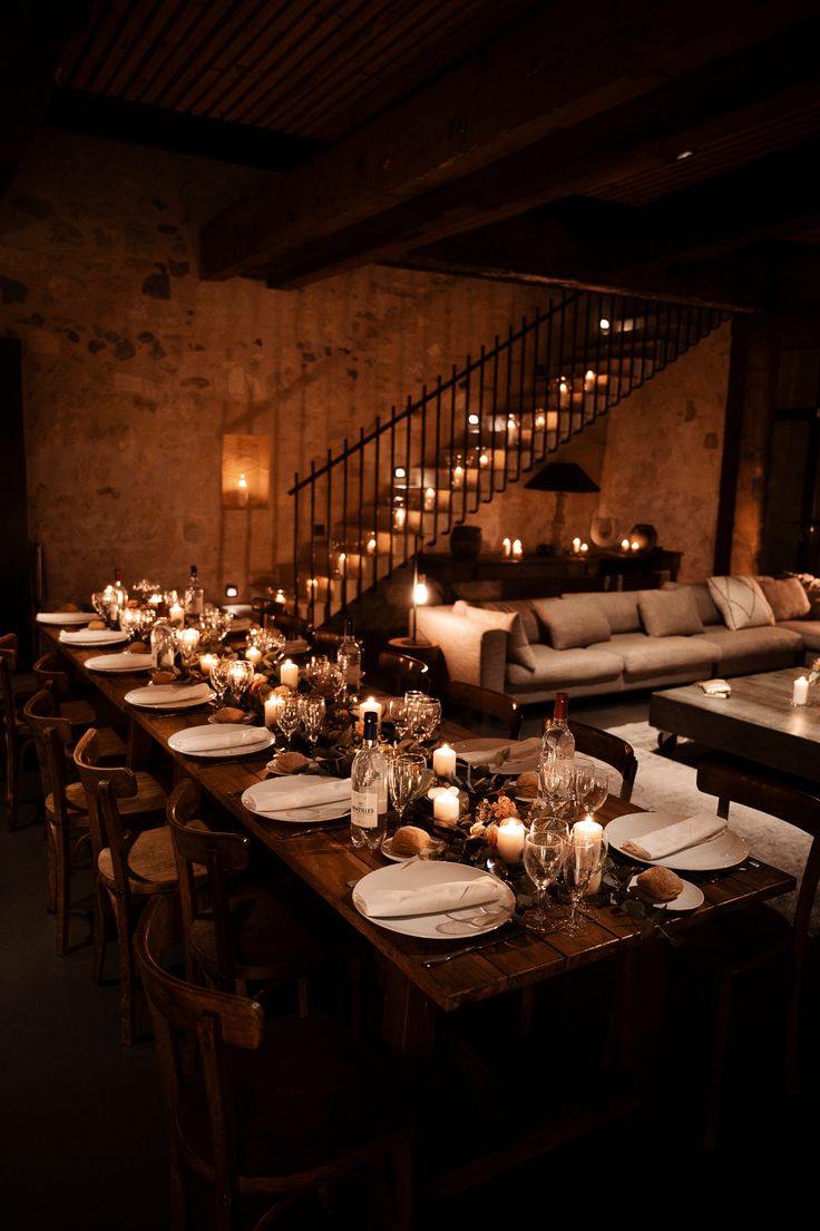 a long table is set with candles and plates