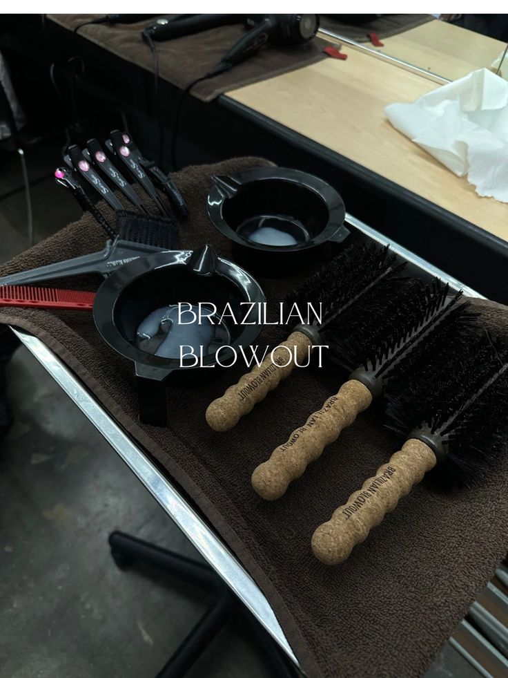 the brushes are sitting on the table with their name written in black and brown letters