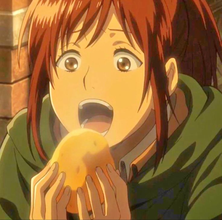 an anime character holding a piece of food