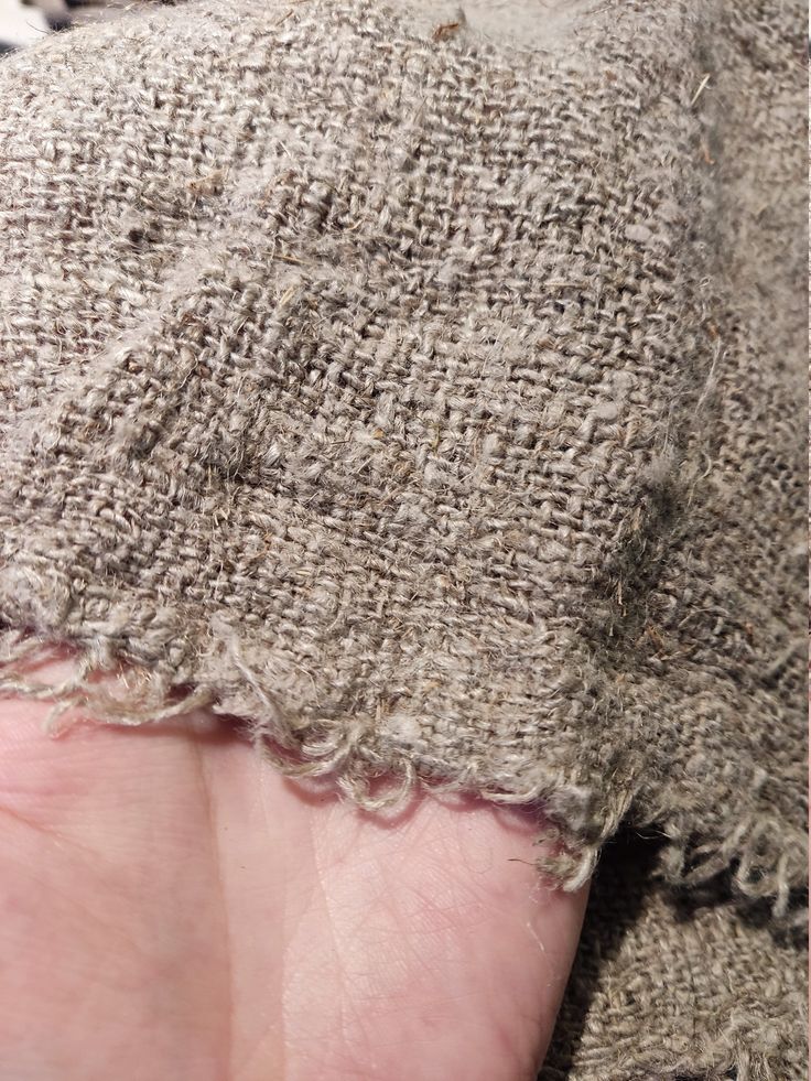 a person's left hand with a piece of fabric on it