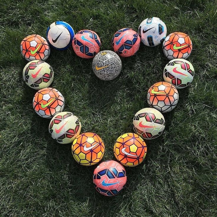 soccer balls arranged in the shape of a heart