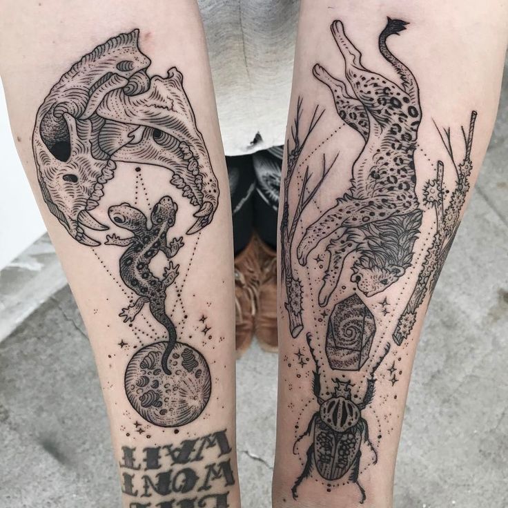 two people with tattoos on their legs, one is holding an animal and the other has a snake