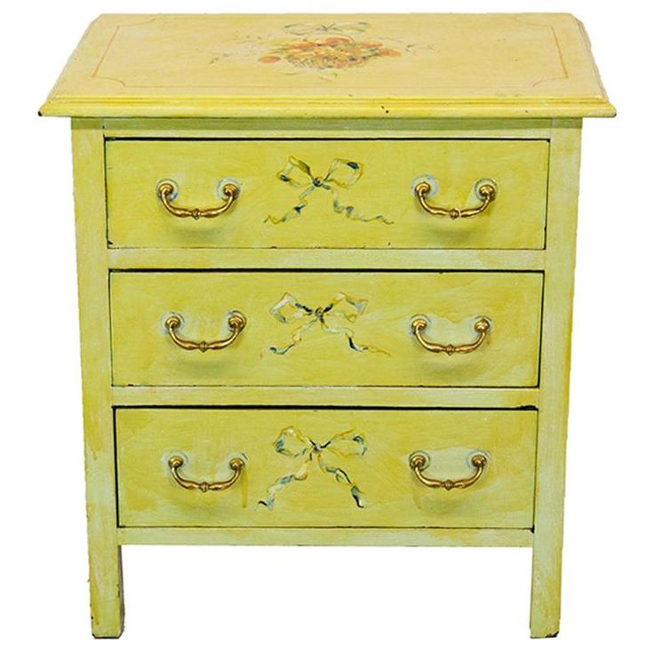 a yellow painted dresser with three drawers