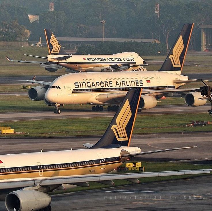 two singapore airlines planes are parked on the tarmac