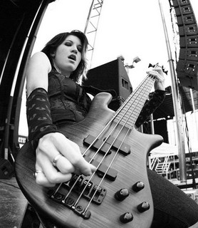 a woman sitting on top of a chair holding a guitar