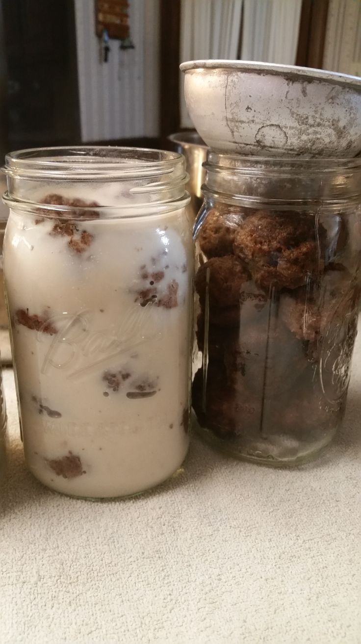 two jars filled with food sitting on top of a table