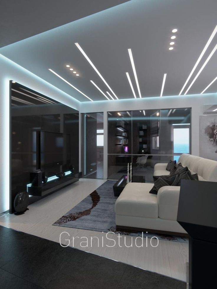 a modern living room with white furniture and lights on the ceiling is lit by recessed lighting