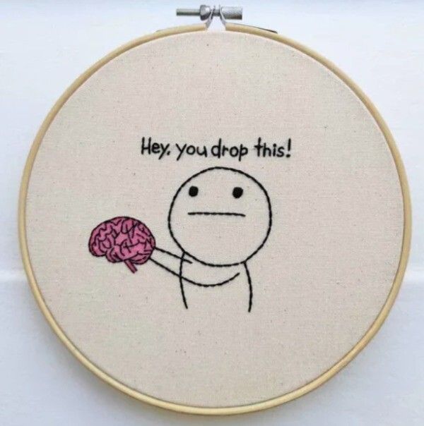 a embroidery project with a drawing of a person holding a brain in one hand and the words hey, you drop this