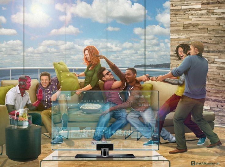 a group of people sitting on top of a couch in front of a flat screen tv