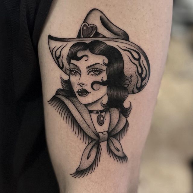 a woman with a hat on her head is shown in black and white tattoo art