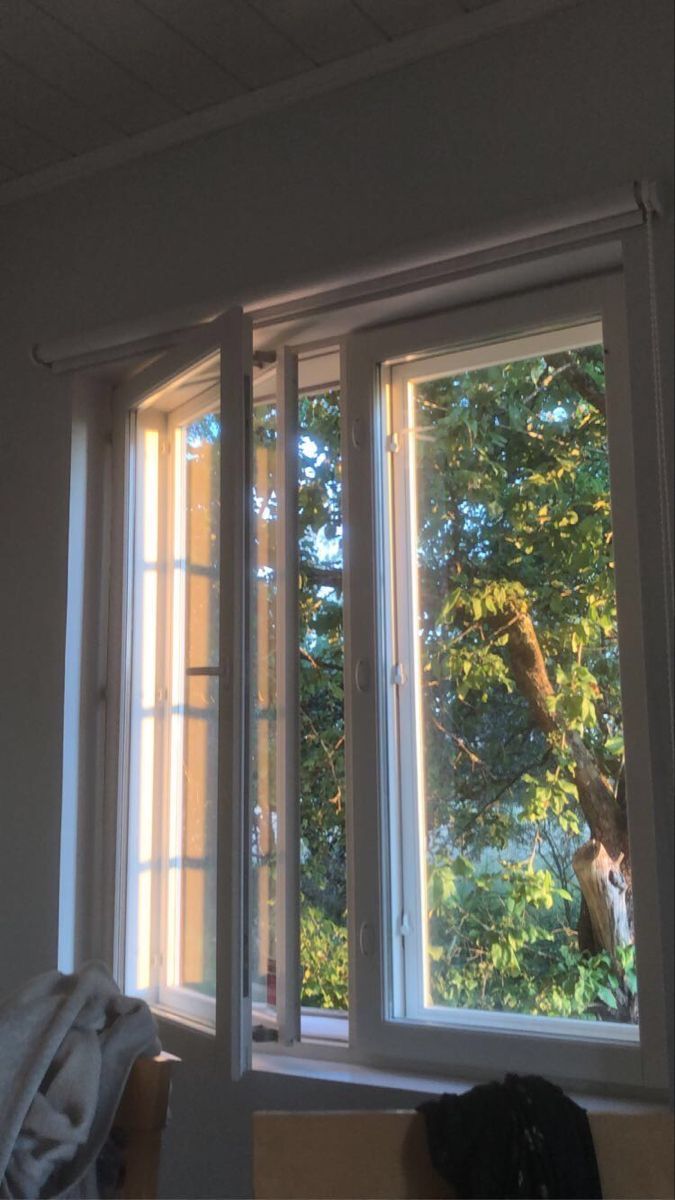 an open window with the sun shining through