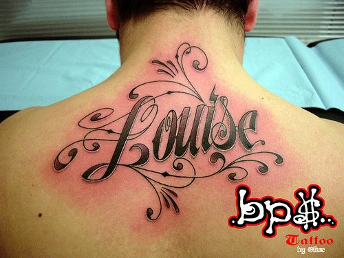 the back of a man's neck with his name tattoo