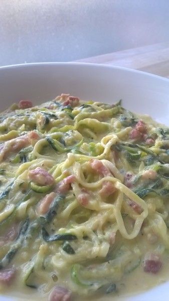 a white bowl filled with pasta and vegetables