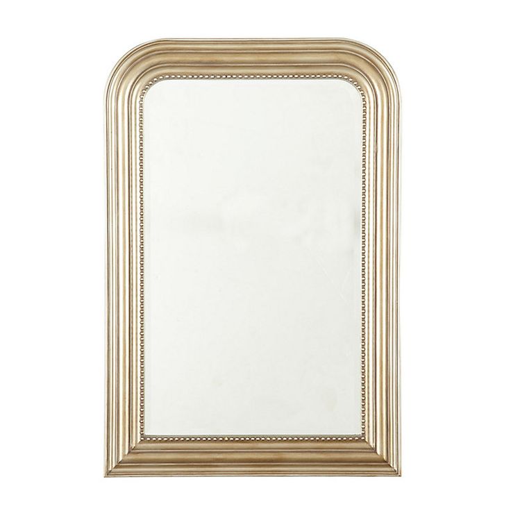 a white and gold framed mirror on a white wall with an empty space in the middle