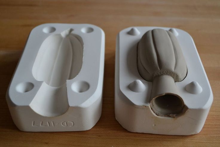 two white electrical devices sitting on top of a wooden table