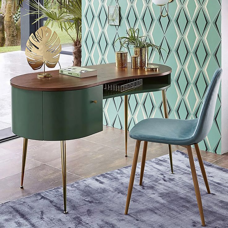 a table with two chairs and a plant on it in front of a green wall