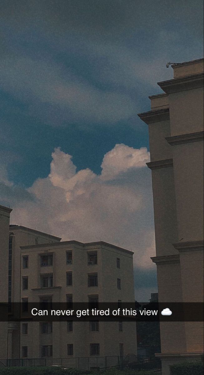 an image of a clock tower in the sky with clouds behind it and text that reads can never get tired of this view