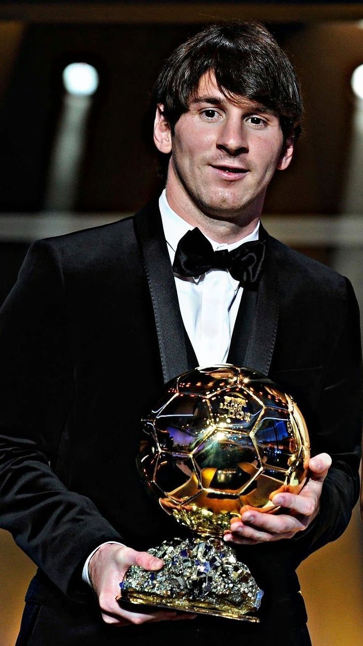 a man in a tuxedo holding an award