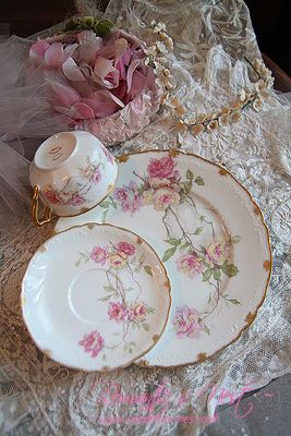 an antique tea set with pink flowers on it