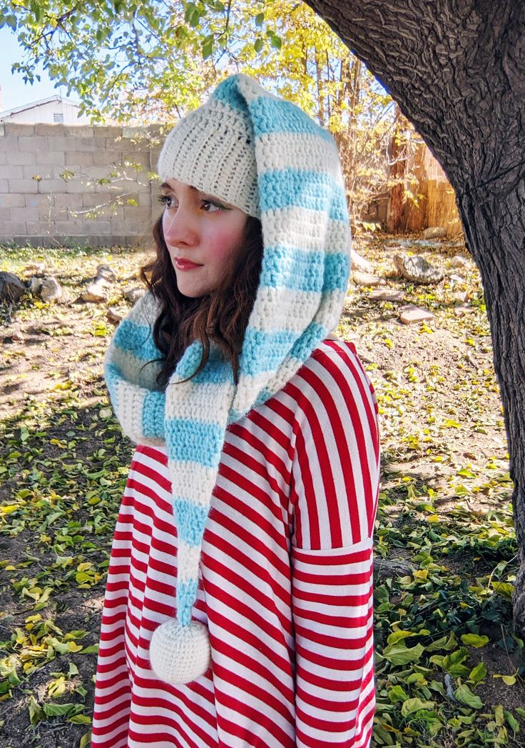 Make an adorable striped elf hat scarf with this crochet pattern! A hat-scarf. A Harf? A Scart? Well whatever you wanna call it, this cute elf hat wraps around your neck and functions as a scarf! It's super cozy and super cute! Read more on our blog! Pattern level: advanced (or ambitious) beginner. Must be comfortable sewing on small pieces, working in the round, changing colors. Sizes included: one size, fits nearly all teens & adults, measures about 62 inches long. Materials needed:- bulky (weight 5) yarn - I've used WeCrochet's Wonderfluff yarn- 4mm and 5mm hooks- yarn needle- stuffing for pom pom ball (you can just use leftover yarn!) What you will receive:A PDF written in English, using US crochet terms, with instructions on how to make this striped elf hat scarf. This is not a finish Crochet Santa Hat Pattern, Crochet Elf Hat Pattern, Crochet Elf Hat, Santa Hat Pattern, Crochet Santa Hat, Wanna Call, Crochet Adult Hat, Crochet Christmas Hats, Crochet Stocking