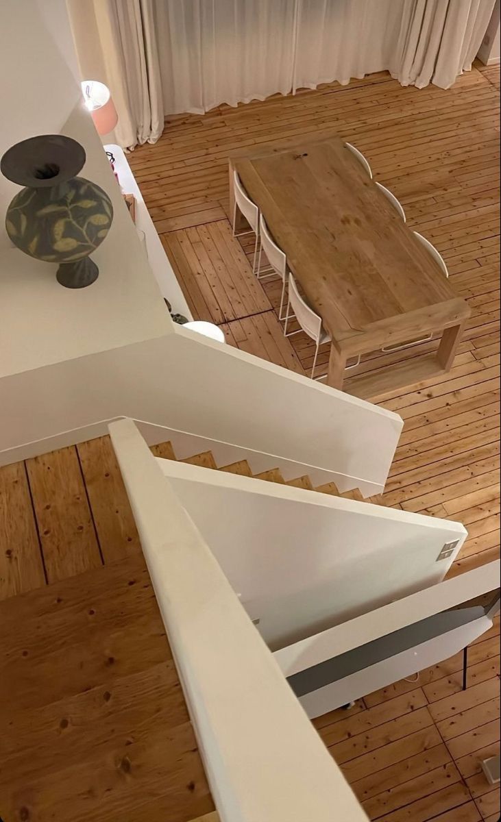 an aerial view of a dining room and living room from the top floor looking down