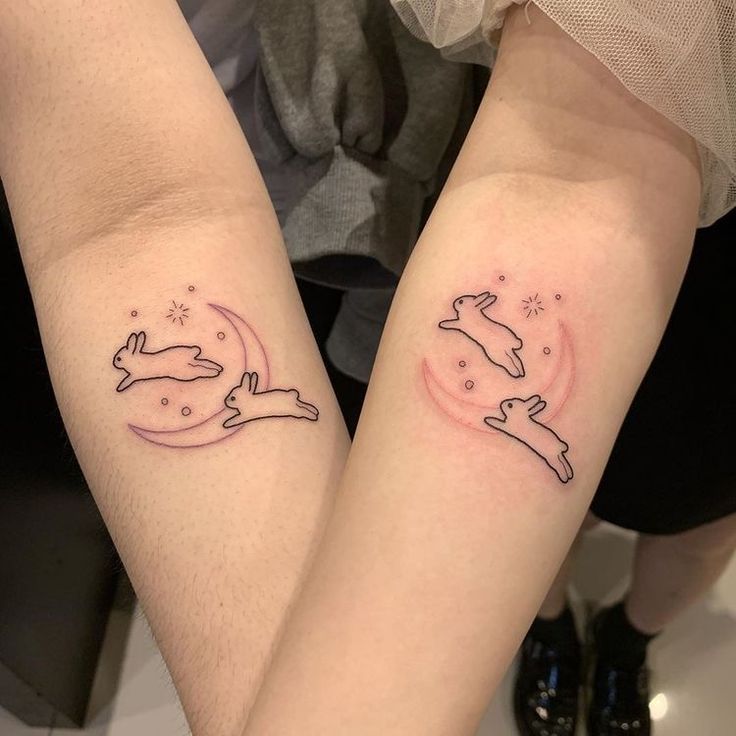 two people with matching tattoos on their arms