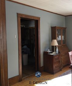 an empty room with wooden furniture and blue walls