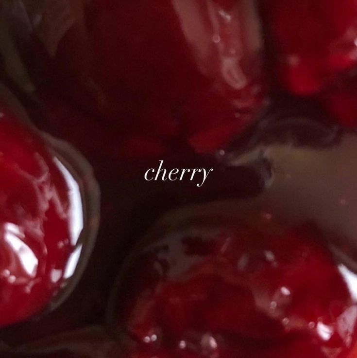 the words cherry are written in cursive font on an image of cherries