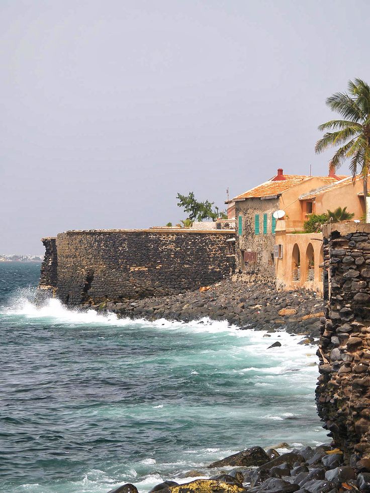 the ocean is choppy with waves coming in to shore and houses on the other side