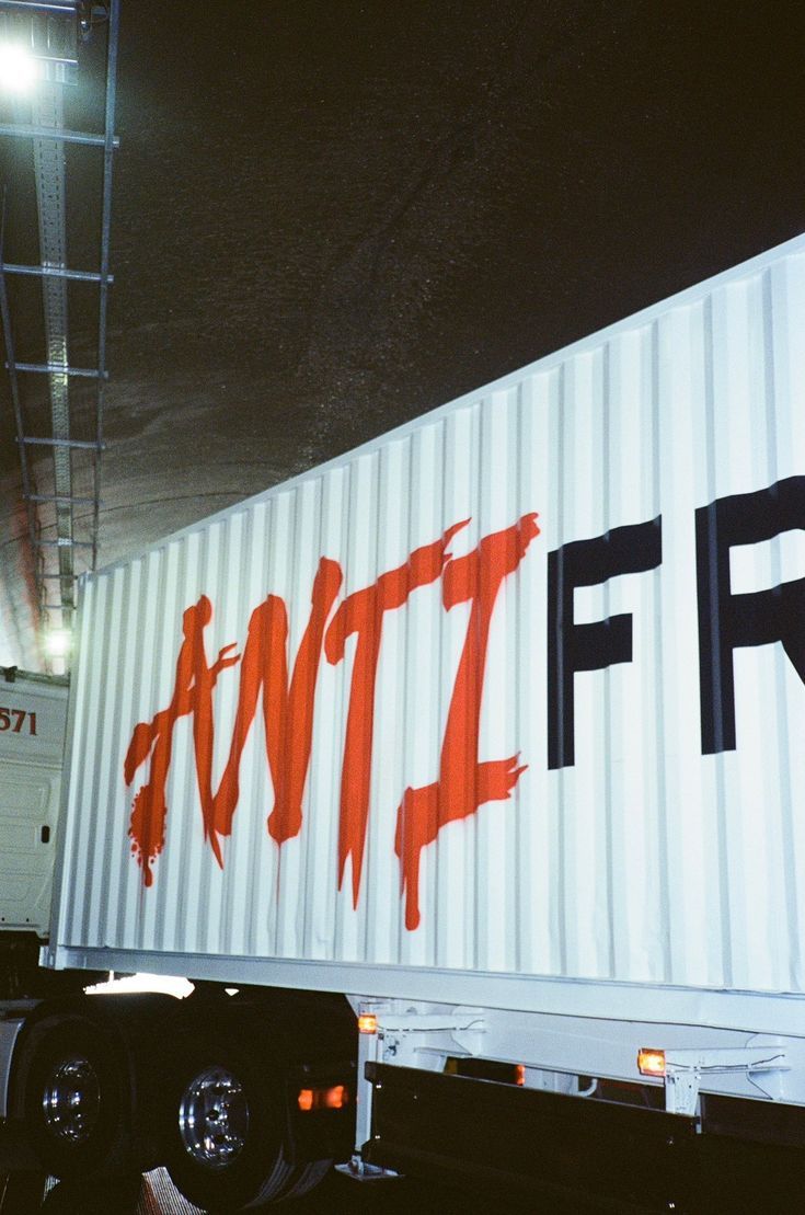 a semi truck with graffiti on it's side and the word f r painted on the back