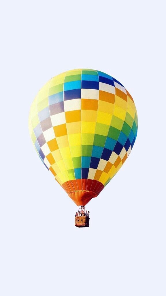 a multicolored hot air balloon flying in the sky