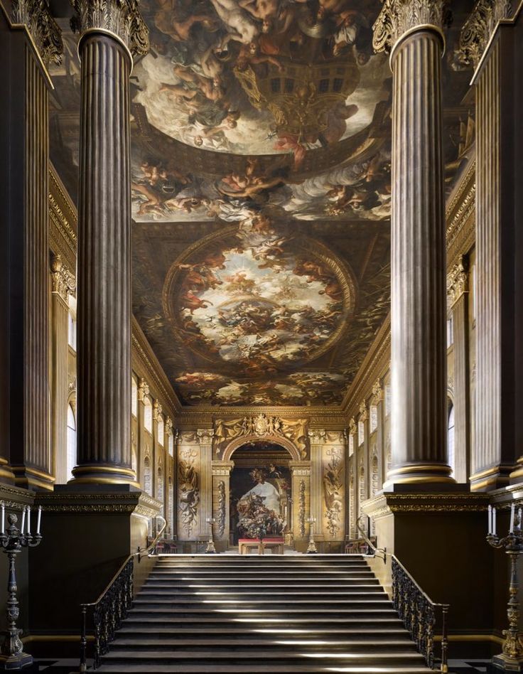 an ornate staircase with paintings on the ceiling