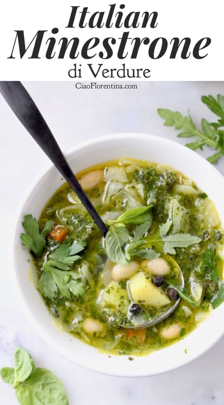 a bowl of soup with broccoli, beans and spinach on the side