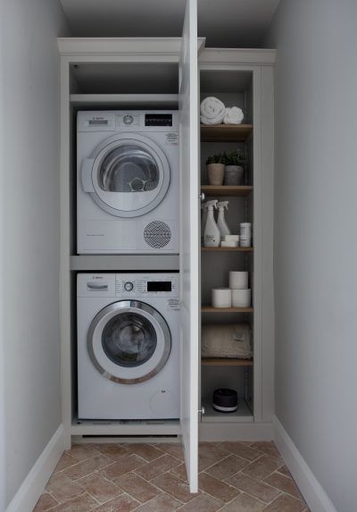 a washer and dryer are in the closet next to each other on shelves