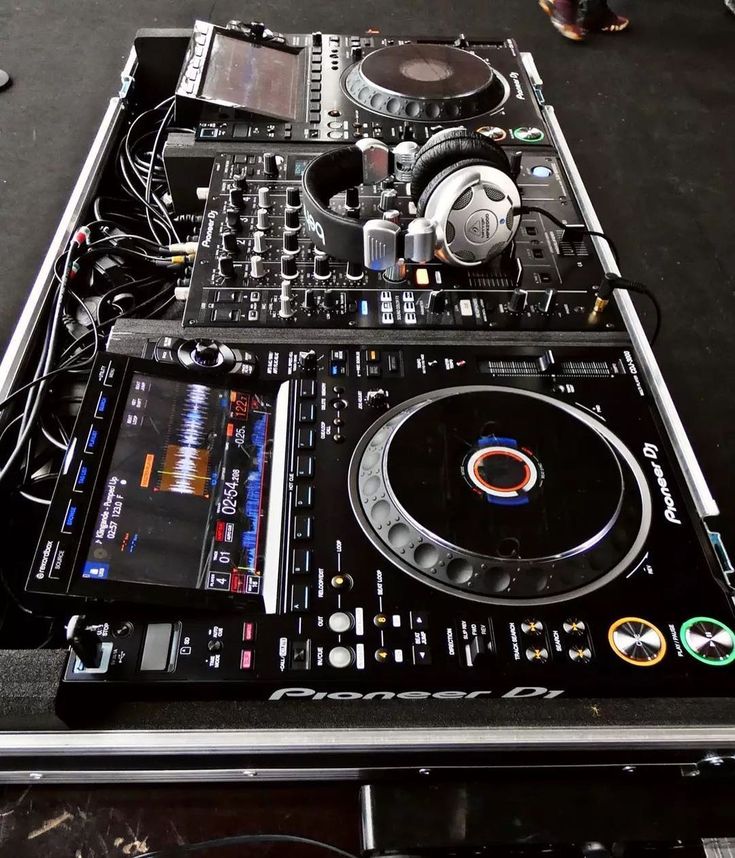 a dj set up with headphones and turntables on it's side