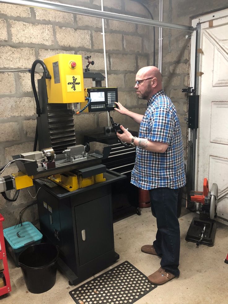 a man standing in front of a machine