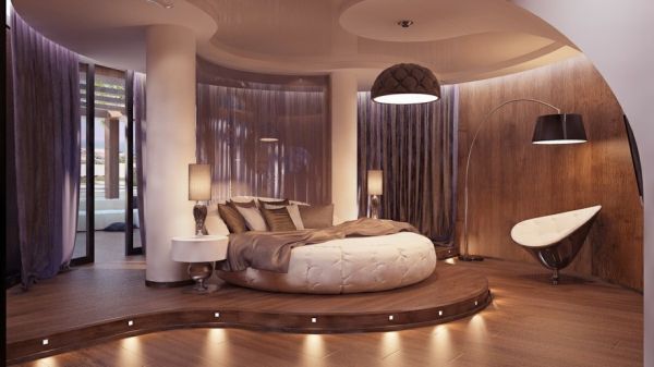 a large bed sitting inside of a bedroom on top of a hard wood flooring