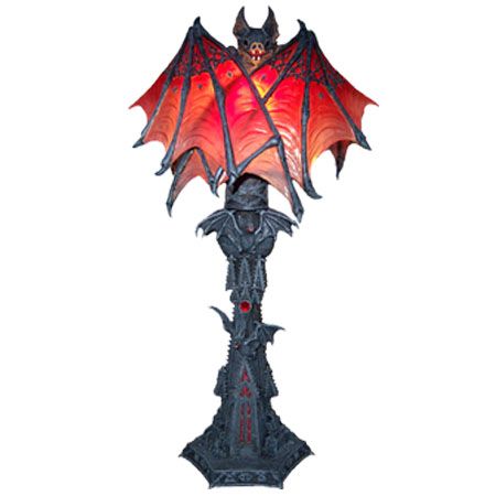 a red and black dragon lamp on a white background