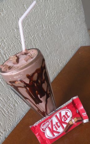 a chocolate milkshake next to a candy bar