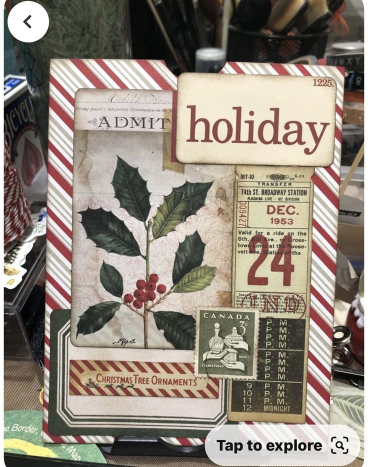 an old fashioned christmas card with holly leaves and red berries on it, is displayed in front of a pile of other holiday cards