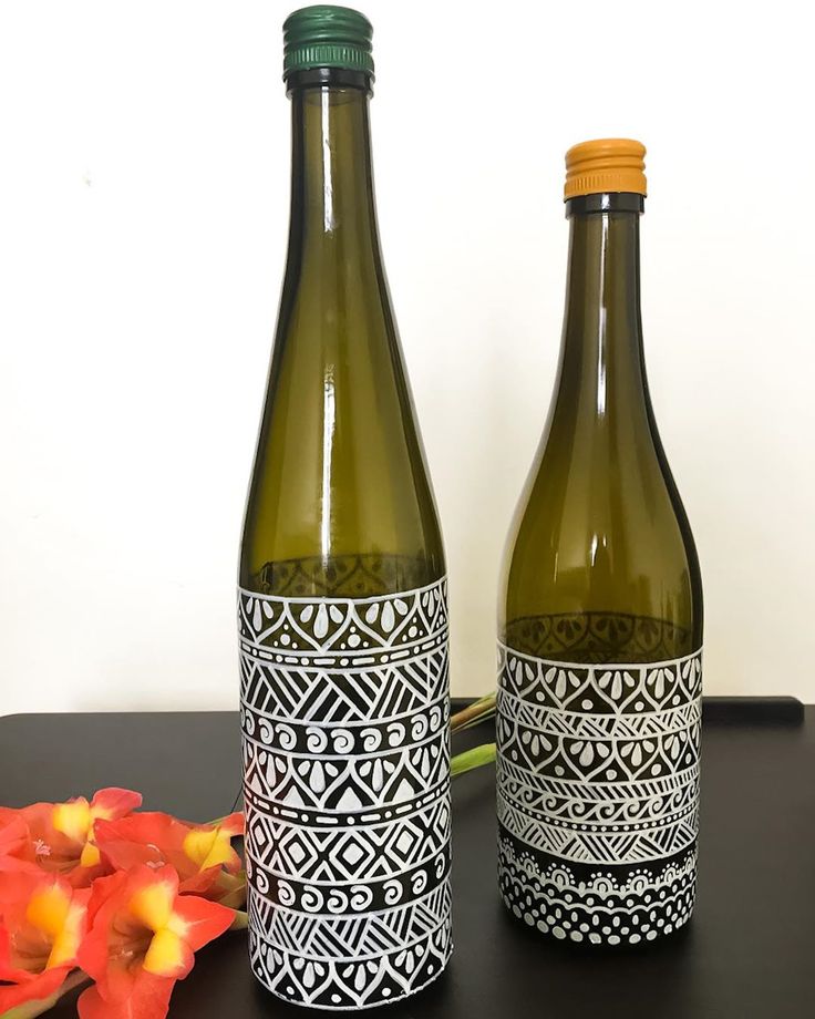 two wine bottles sitting next to each other on a table